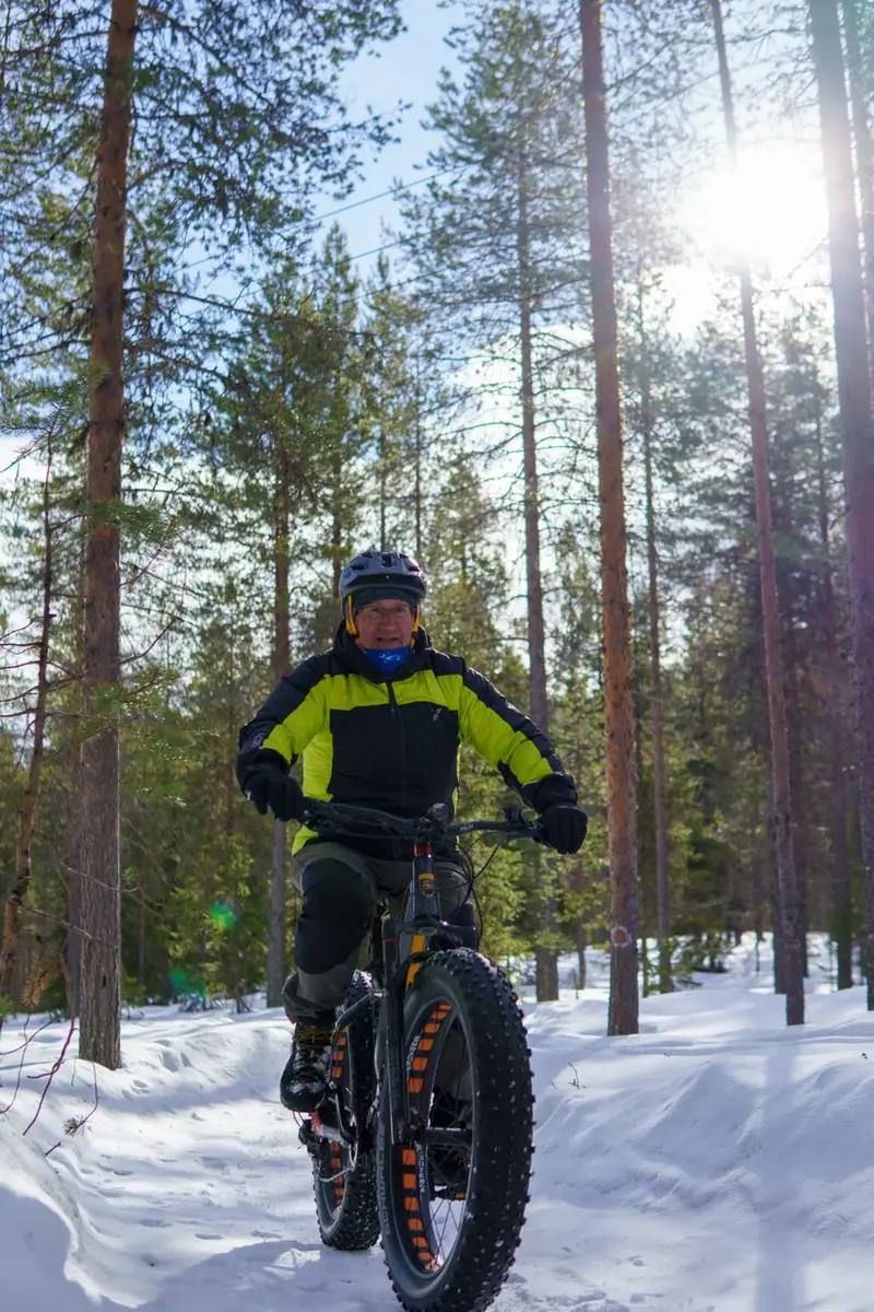 Electric bike with dual hub motors riding through snow on a forest trail