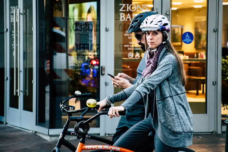 Cyclist wearing a helmet riding on a city street