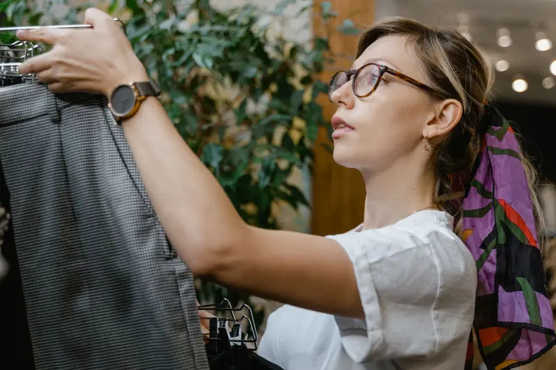 Person looking at bicycles in a bike shop, choosing between models