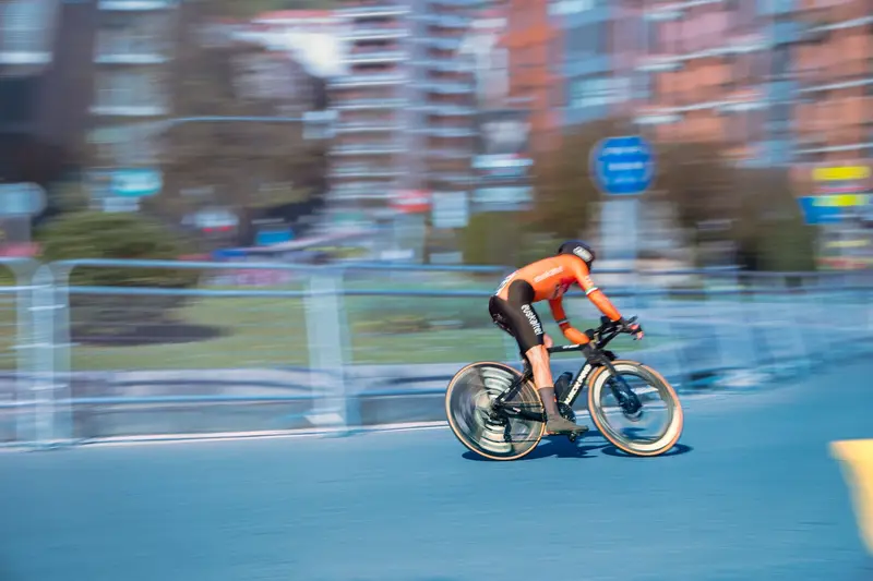 Cyclist riding an electric bike at speed along an open road